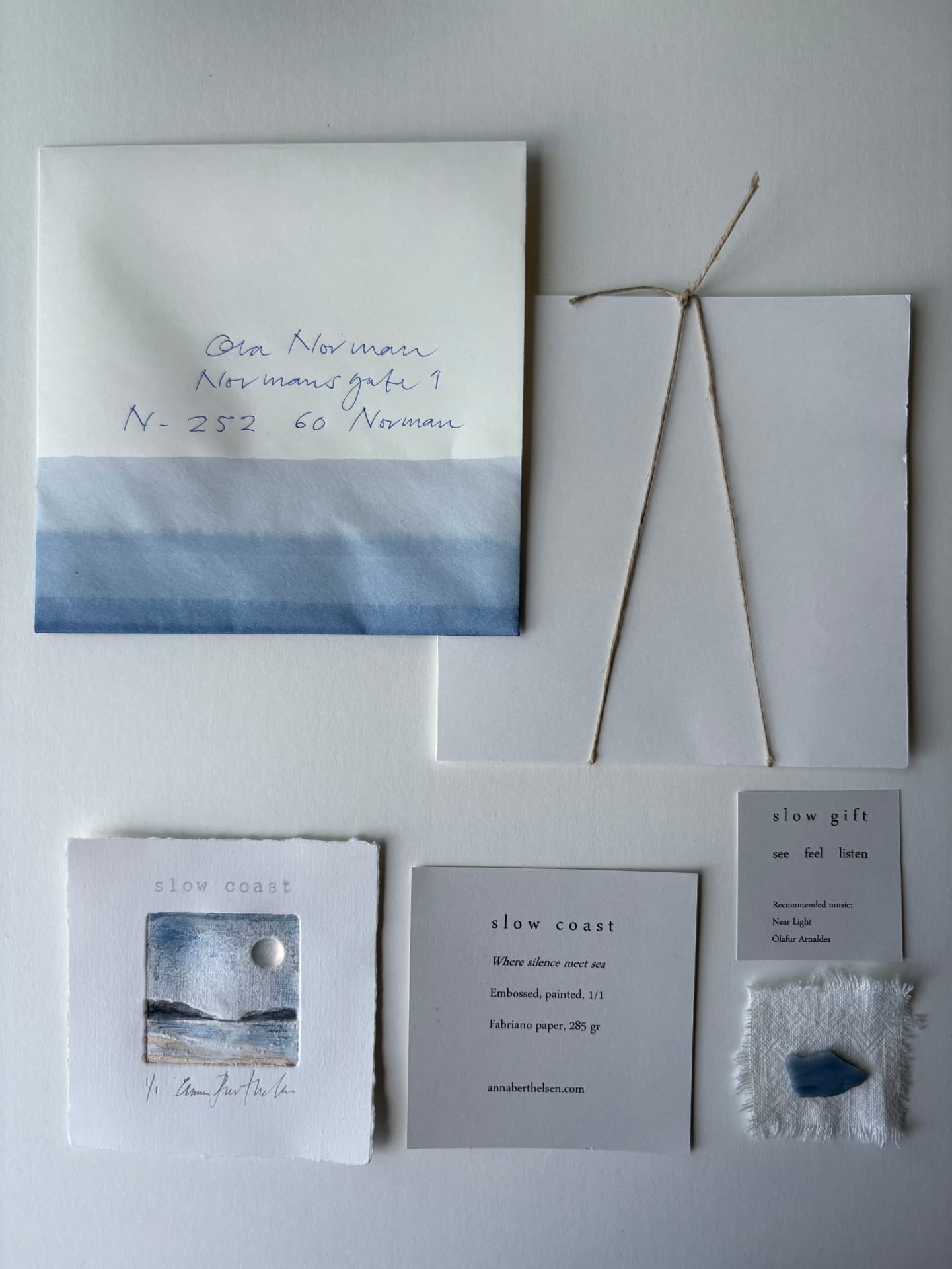 Hand painted envelope, print and slow gift laid out