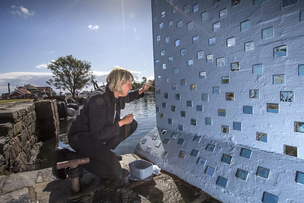 Anna placing mirror tiles on the Slow Bridge